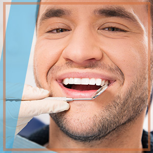 Man smiling as dentist looks at teeth